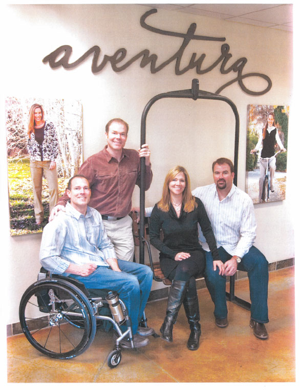 John, Michael, Kathleen and Tom in front of Aventura logo sign.