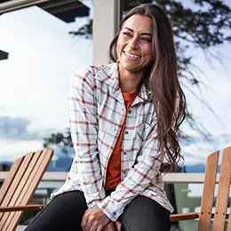 Woman sitting outside wearing the Luscious shirt.